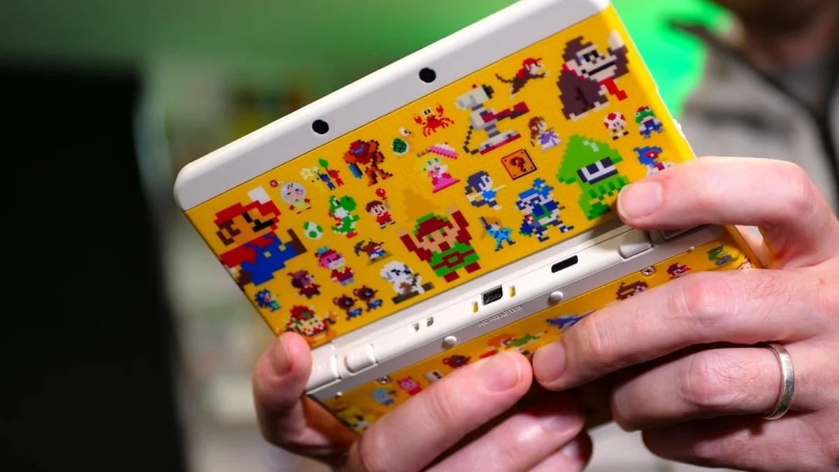 New Nintendo 3DS handheld console held in hands illustrating the October 2026 Nintendo network maintenance