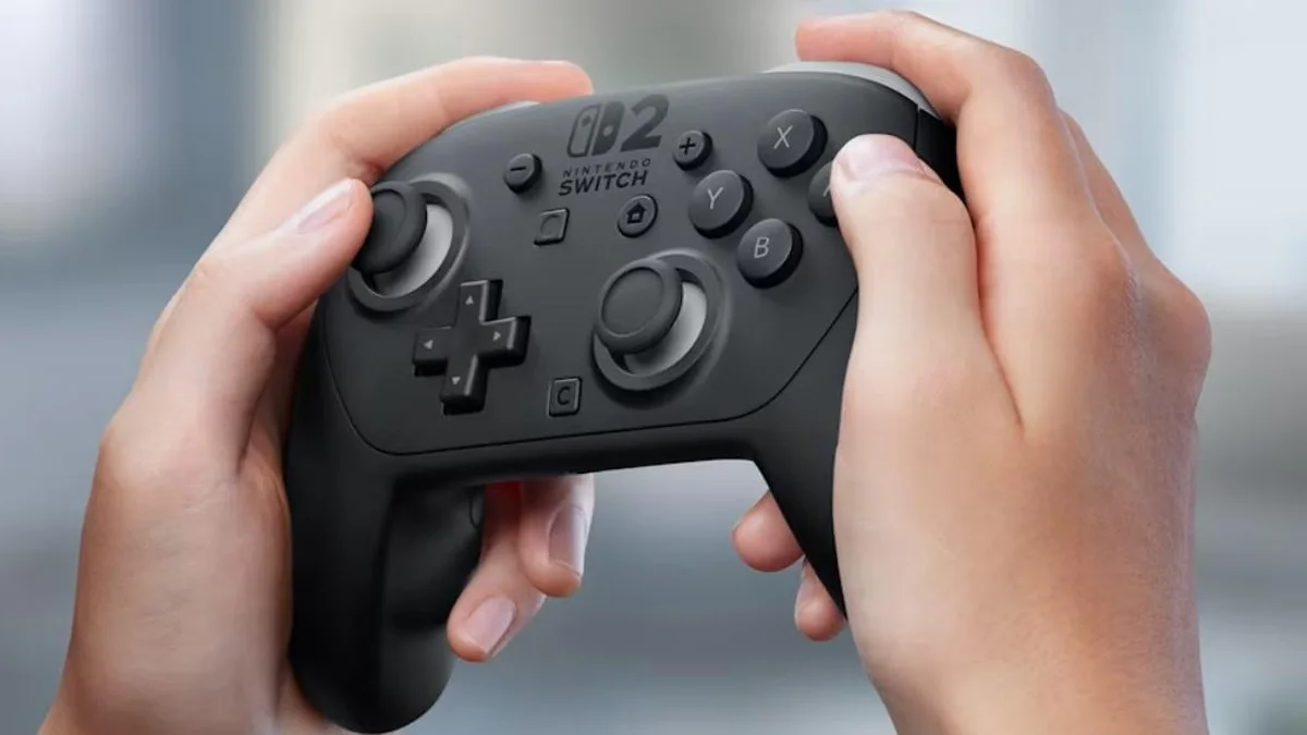Official Nintendo Switch 2 Pro Controller held in hands showing C button for GameChat