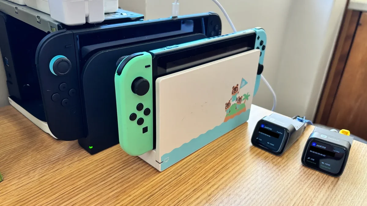 Nintendo Switch 2 automated jailbreak test rig with JetKVM units and SwitchBot button presser for ns2jb