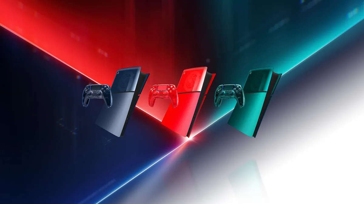 The three transparent PS5 console covers and matching DualSense wireless controllers in Graphite Gray, Flare Orange, and Emerald Green