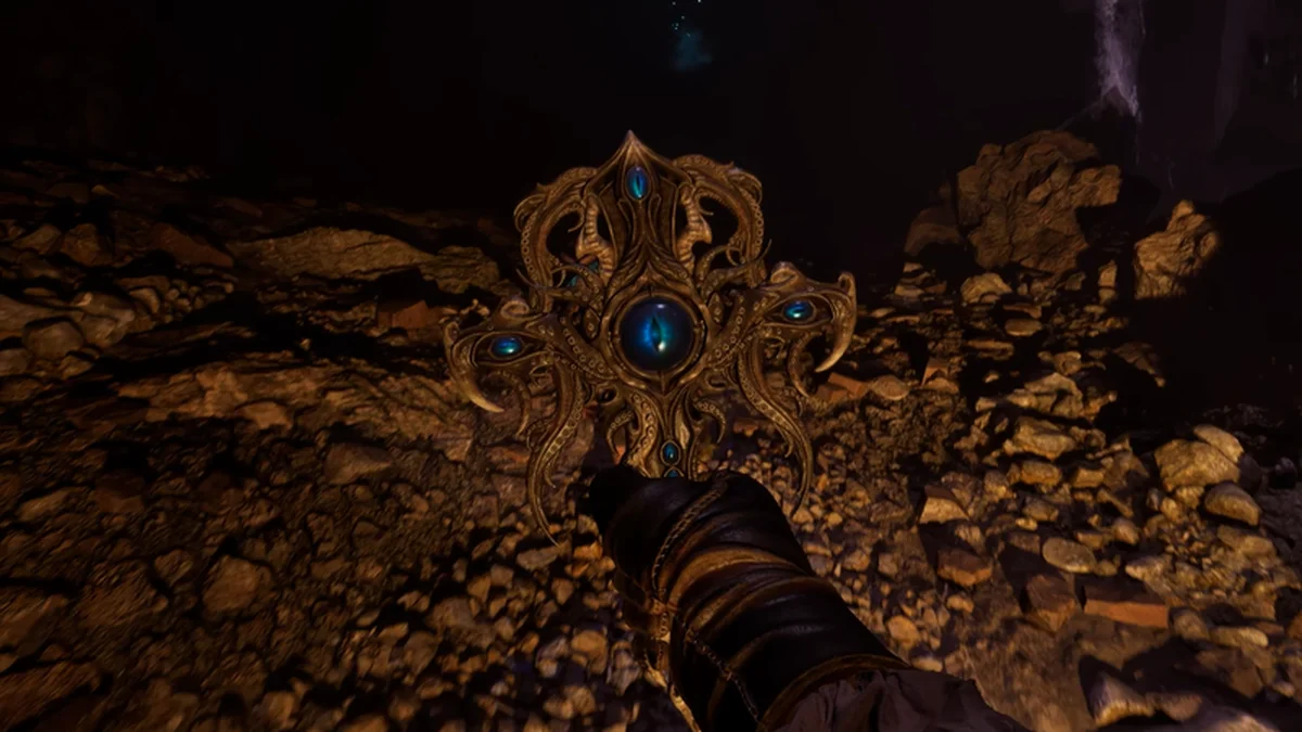The Eye of Servitude occult relic held in the darkness in The Mound: Omen of Cthulhu